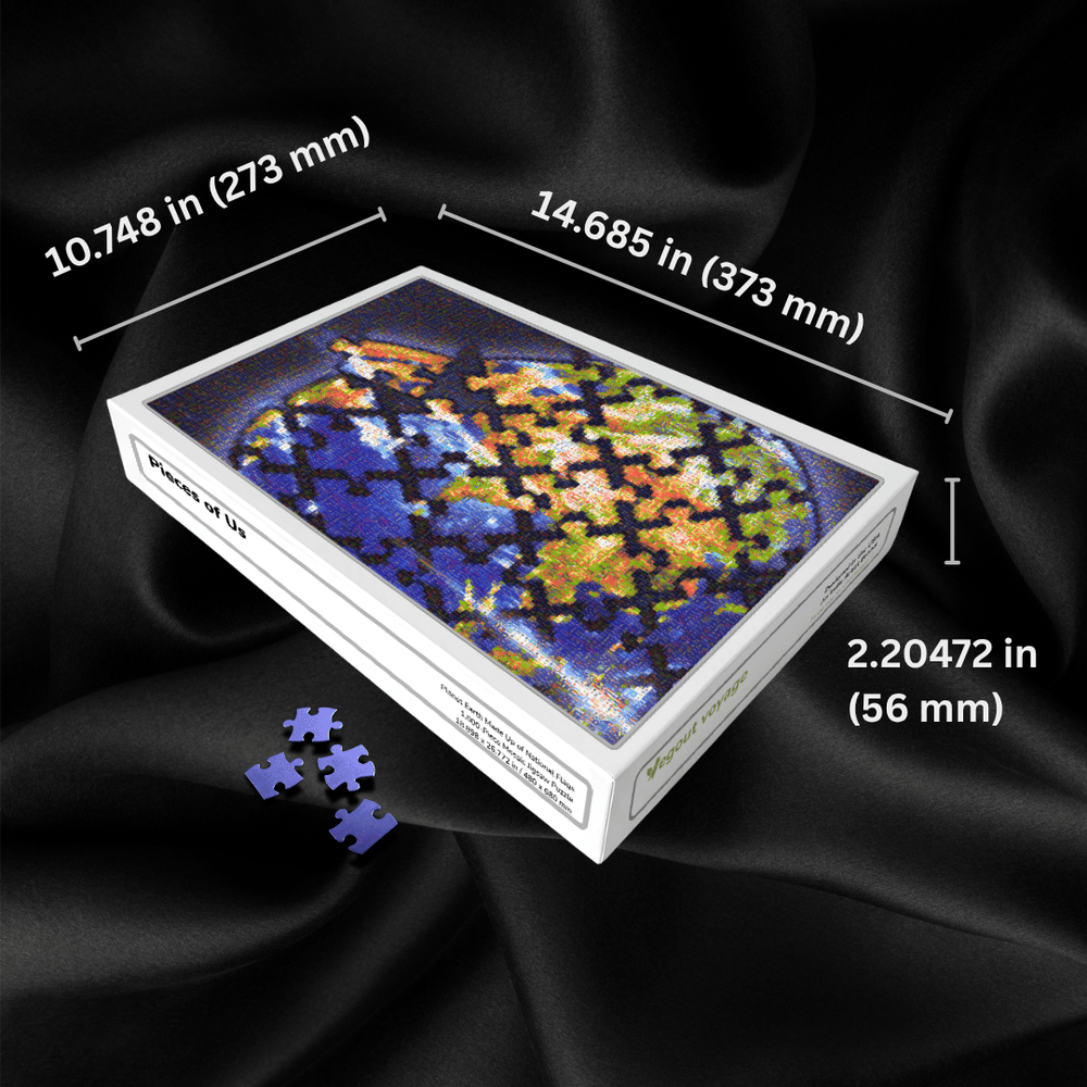 A jigsaw puzzle box showing a colorful globe design with partially assembled puzzle pieces scattered in front, set against a black satin background with overlaid dimension lines and text indicating the box measurements.