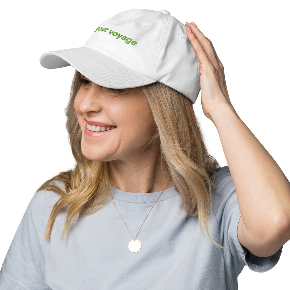 Woman wearing a white cap with 'vegout voyage' text on a white background