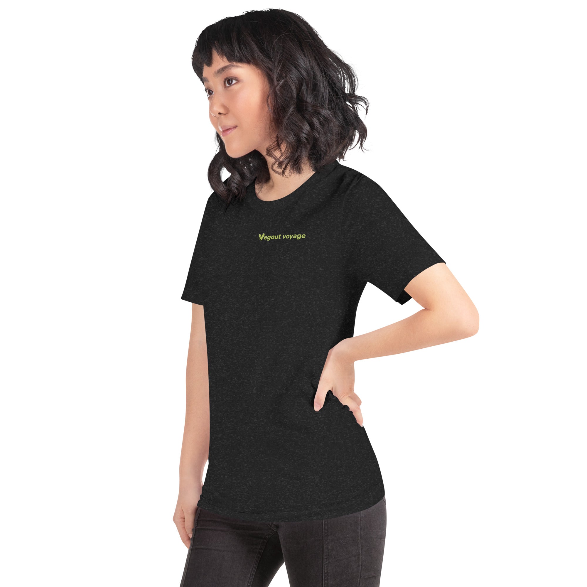 Side view of woman in black Vegout Voyage t-shirt with green logo